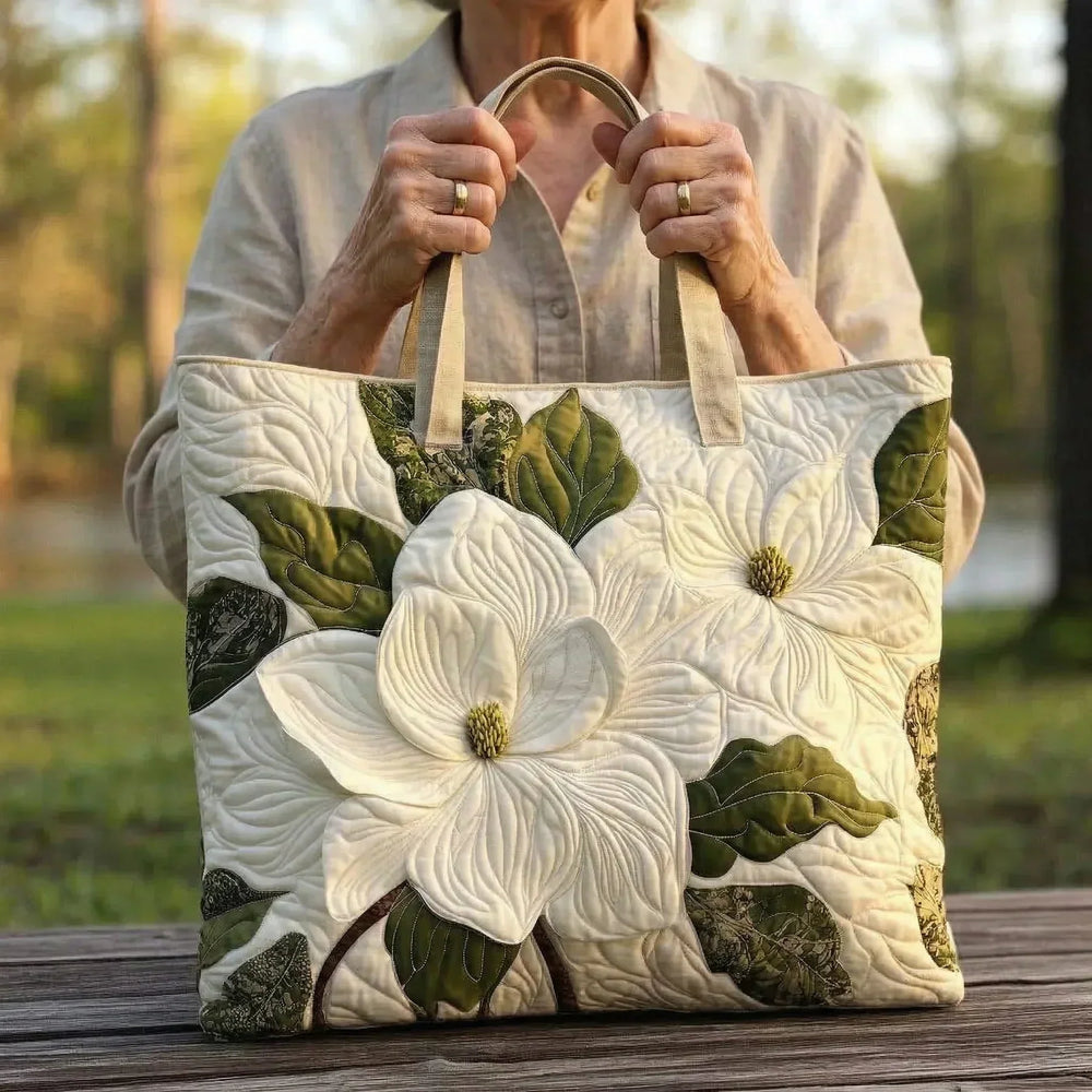 Elegant White Lilies quilted tote bag carried by hand