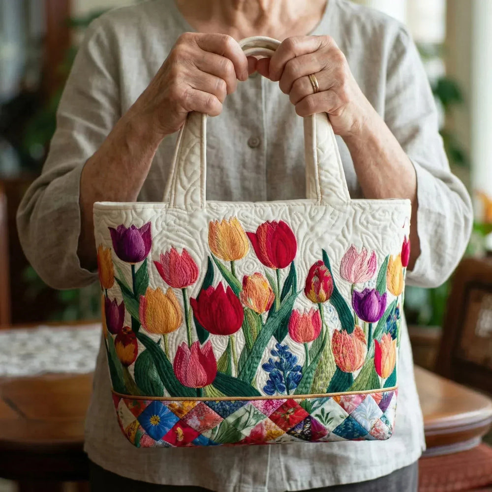 Tulip Garden quilted tote bag carried by hand