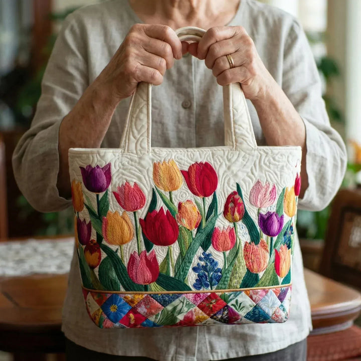Tulip Garden quilted tote bag carried by hand